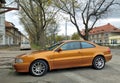 Old elegant veteran classic saffron pearl metallic coupe car Volvo C70 parked