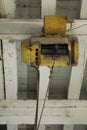 Old eletric winch attached to the ceiling in old factory. Royalty Free Stock Photo