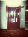 Old elevator from the 70s adapted to new uses. Purple door. Photo in a vintage style.