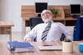 Old male employee suffering from radiculitis at workplace