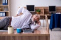 Old male employee suffering from radiculitis at workplace Royalty Free Stock Photo