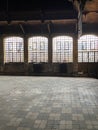 Old emptied school sports hall dramatic natural lighting Interior of an building with windows brick floor