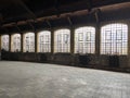 Old emptied school sports hall dramatic natural lighting Interior of an building with windows brick floor