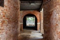 Old, empty arched hall or passage made of bricks with wooden beams in Venice, Italy