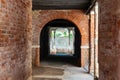 Old, empty arched hall or passage made of bricks with wooden beams in Venice, Italy