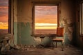 an old, empty chair in an abandoned house, facing a window with a sunset view Royalty Free Stock Photo