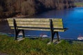 Lakeside bench with frozen lake in background Royalty Free Stock Photo