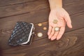 Old empty wallet and coins in the hands .Vintage empty purse and coins in hands of women . Poverty concept. Bankruptcy Royalty Free Stock Photo