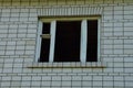 Old empty window with wooden frame on a gray brick wall of an abandoned house Royalty Free Stock Photo