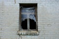 Old empty window with wooden frame on a gray brick wall of an abandoned house Royalty Free Stock Photo