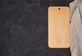 Old empty wooden cutting board on black background, top view Royalty Free Stock Photo