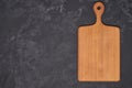 Old empty wooden cutting board on black background, top view Royalty Free Stock Photo