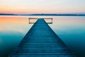 Old empty wooden jetty on lake, during sunrise Royalty Free Stock Photo