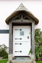 Old English doorway with thatched roof