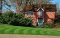 An old English house with striped lawn in the foreground. Royalty Free Stock Photo