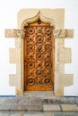 Old entrance door of an ancient building with a graceful pattern Royalty Free Stock Photo