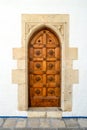 Old entrance door of an ancient building with a graceful pattern Royalty Free Stock Photo