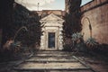 An Old Entrance Door Gate to a House with Big Stairs, Surrounded by Brick Walls and a Small Garden Royalty Free Stock Photo