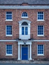 Old European brick facade with windows and columns in a symmetric Royalty Free Stock Photo