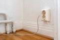 Old european electricity socket with cables on the wall