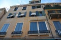 An old European house with beautiful retro shutters on the windows,