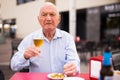 Old man on restaurant terrace with glass of beer Royalty Free Stock Photo