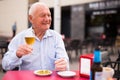 Old man on restaurant terrace with glass of beer Royalty Free Stock Photo