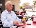 Old man on restaurant terrace with glass of beer Royalty Free Stock Photo