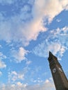 Old vintage classic tall clock tower with blue sky