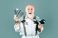 Old excited amazed barber with barber equipment tools.