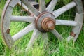 Old exhibit with the wagon wheel on a green grass. Wheel cart grass close-up Royalty Free Stock Photo