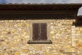 Old exterior of an italian mediterranean village house with closed wooden vintage window with brown blinds Royalty Free Stock Photo