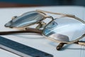 Old eyeglasses and a ruler for drawing lie on the table on a white background. Glasses on the table