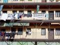 Old facade with balconies and clothes hang on it in Lavapies district of Madrid, Spain. Type of Spanish housing known as corrala. Royalty Free Stock Photo