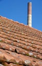 Old factory roof with roof tiles and brick chimney Royalty Free Stock Photo