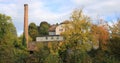 Old factory Schoenau surrounded by colorful trees Royalty Free Stock Photo