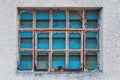 Old factory warehouse grid windows with broken glass Royalty Free Stock Photo