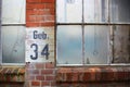 Old factory windows with the German inscription Geb. 34 (building 34) Royalty Free Stock Photo