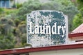 Old faded green laundry sign for public laundromat Royalty Free Stock Photo