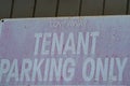 Old faded metal sign rusted with white words tenant parking