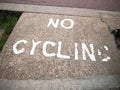 An old and faded sign printed on the floor saying no cycling Royalty Free Stock Photo