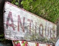 Weathered ANTIQUES sign