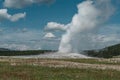 Old Faithful Geyser erupting during the day in Yellowstone National Park Royalty Free Stock Photo