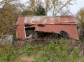 Old falling down, abandoned corrugated shed in the countryside