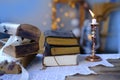 Old family photos in vintage interior, stack nostalgic sentimental pictures, candle burning, relic box, stack of books, concept