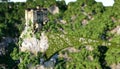 Old fantsay castle on a high cliff, rock. Aerial view. fabulous landscape