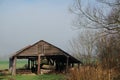 Old Farm building against a blue / white sky