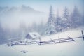 Old farm in the foggy mountains in winter. Royalty Free Stock Photo