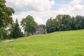 Old farm house historic timbered barn with green meadow pasture Royalty Free Stock Photo