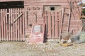 Old farm shed wall with collection of junk and implements with truck door Royalty Free Stock Photo